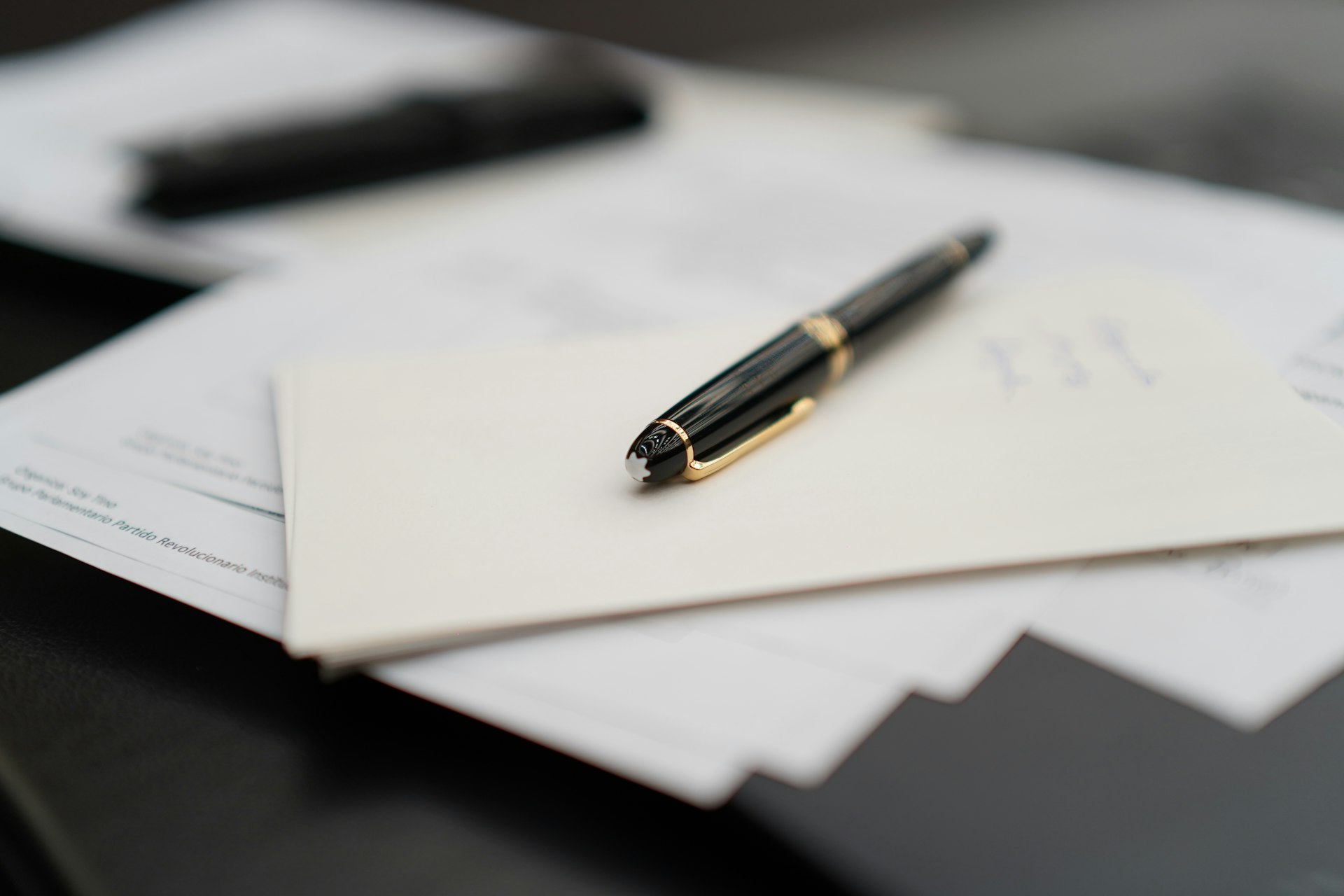 Fountain pen resting on business contracts